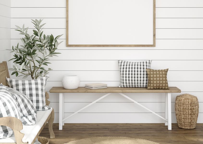 wooden bench with white painted legs and checked cushions