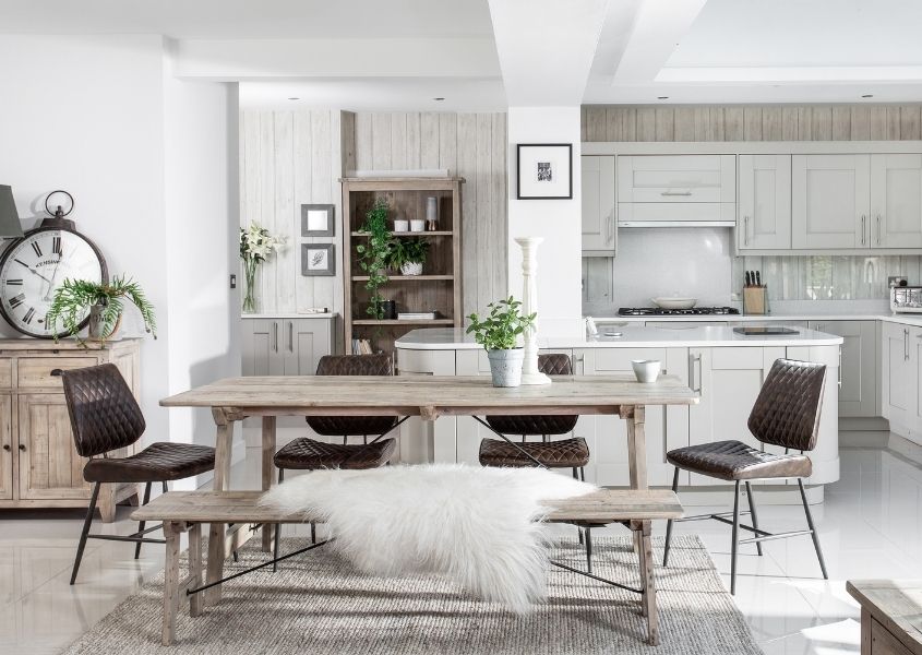 reclaimed wood dining tale with matching wooden bench and brown faux leather dining chairs