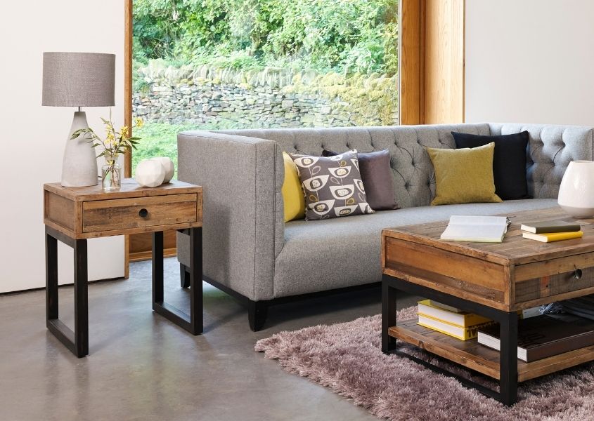 industrial side table next to grey fabric sofa