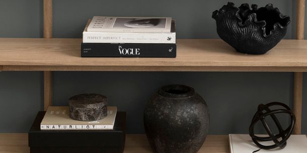 wooden bookcase with black ornaments