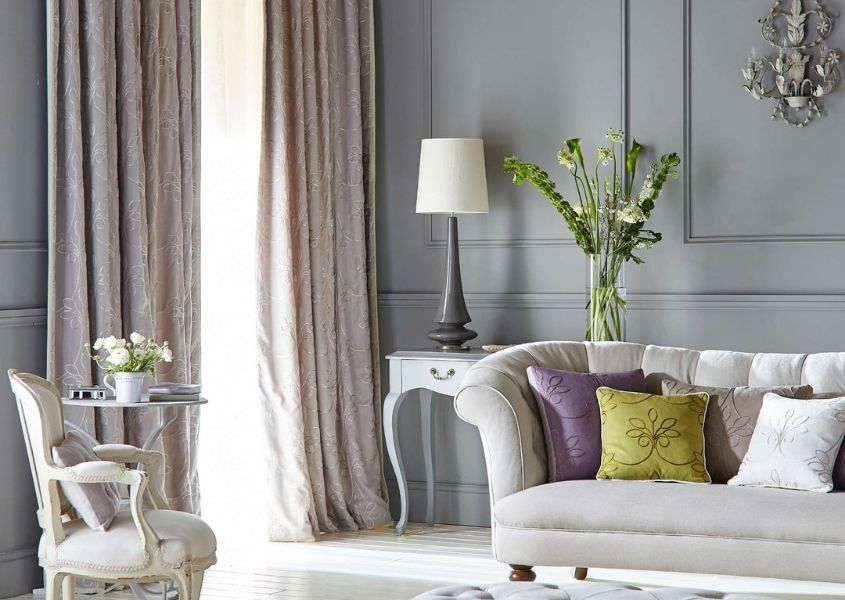 living room with high ceiling and cream sofa for how to add grandeur to a living room blog