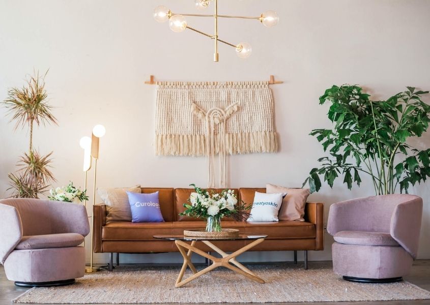 Brown leather sofa with wall boho wall hanging