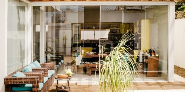 Outdoor patio with rattan sofa and large glass window