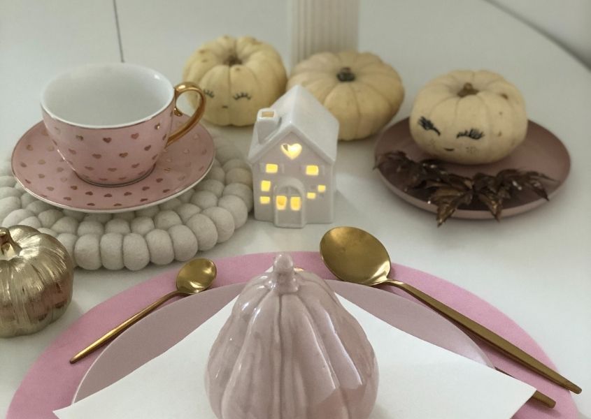 pink dinner plate on wooden dining table with cream painted squashes