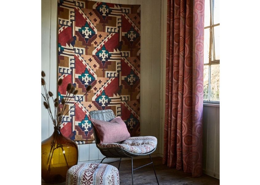 Multi-coloured aztec wall tapestry with wire dining chair and matching cushion