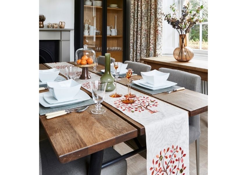 Industrial dining table with patterned cream and red runner