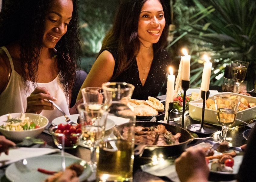 Women at a dinner table for How to host the perfect dinner party blog