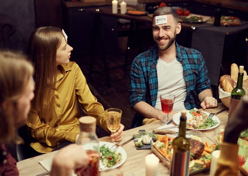 People playing games around a wooden dining table