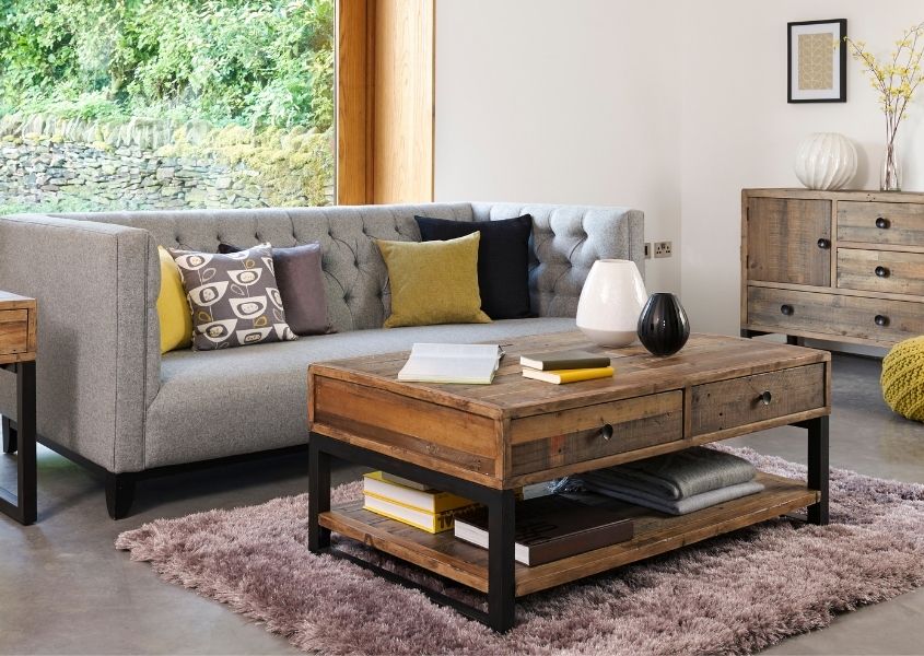 Reclaimed wood coffee table next to grey fabric sofa