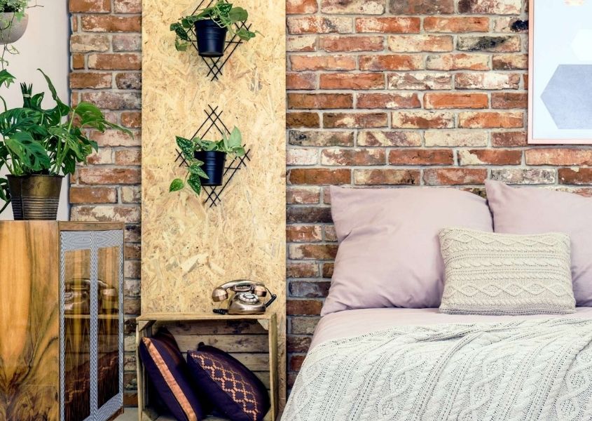 Industrial style bedroom with industrial furniture and exposed brick wall
