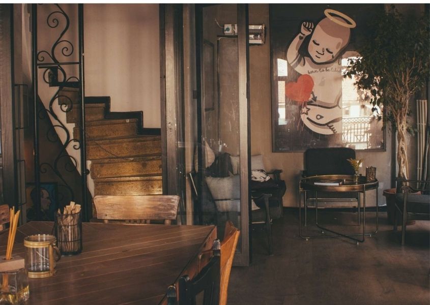 Dining room with wooden table and large artwork on wall