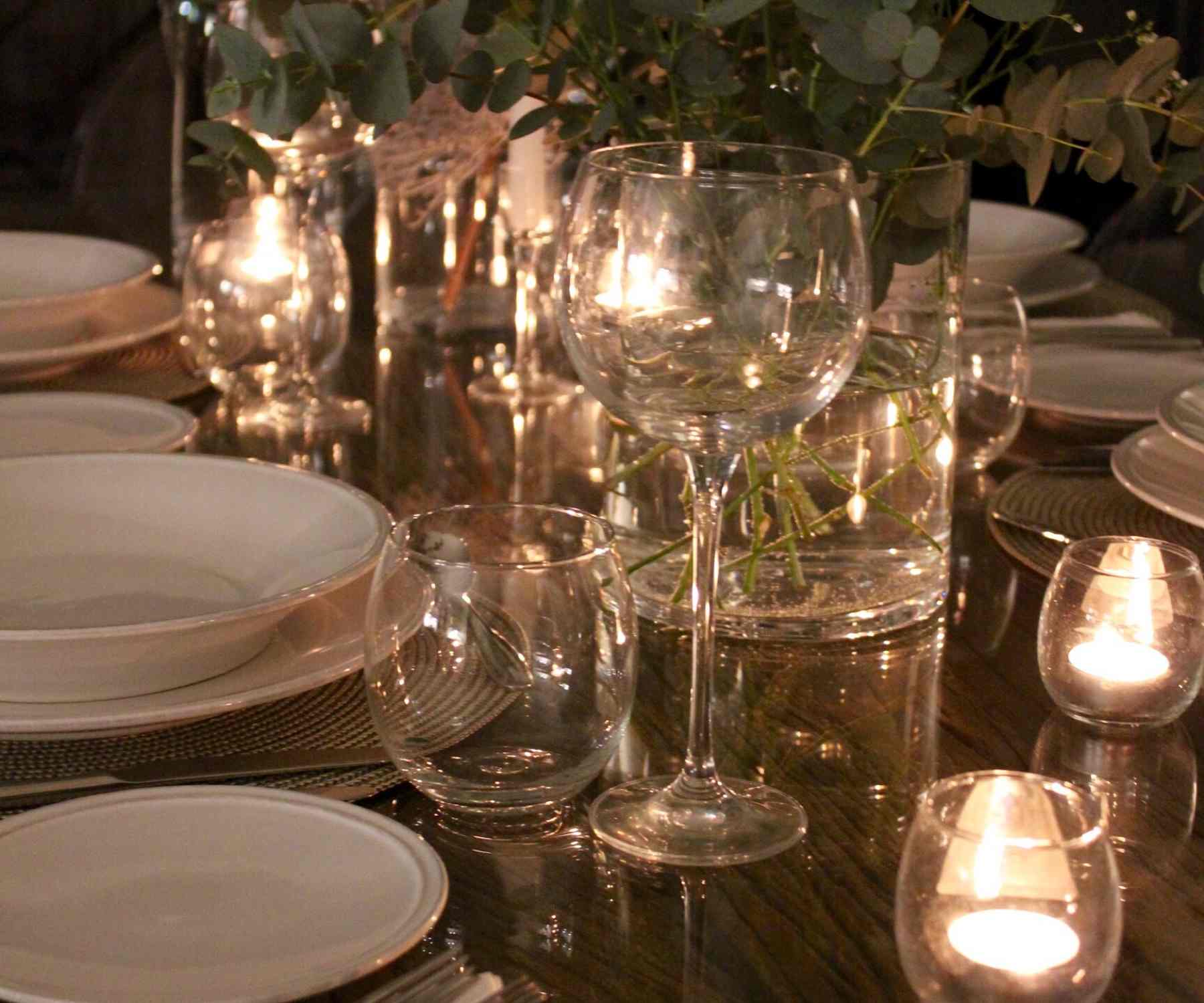 Fairy lights and tea lights on a reclaimed wood dining table