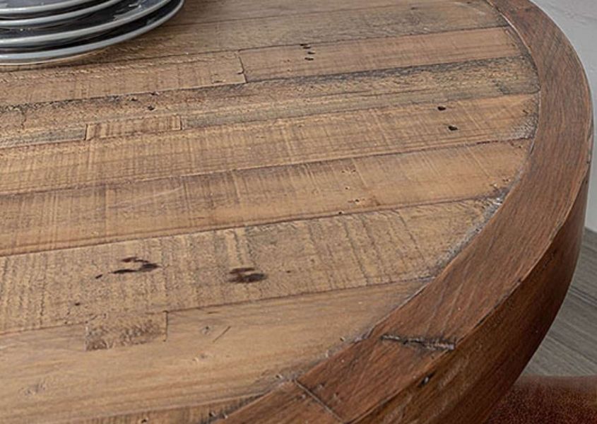 Close up of round dining table made in reclaimed wood