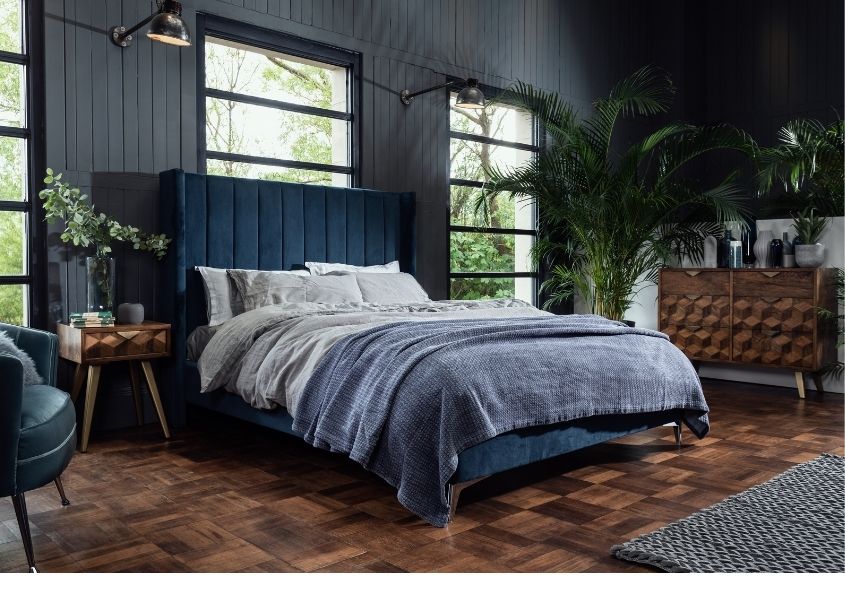 blue velvet bed with mango wood bedside table and mango wood chest of drawers