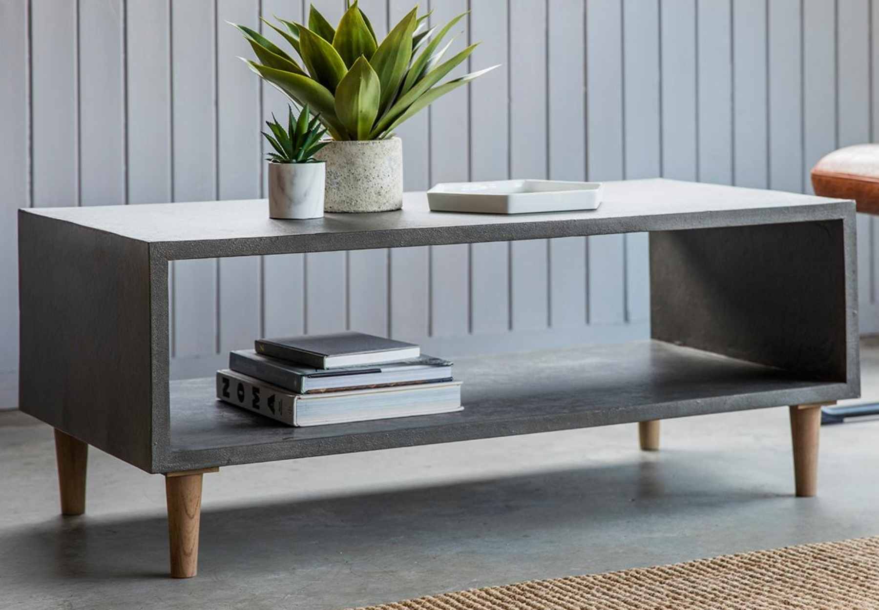 Cube coffee table with green plant and books