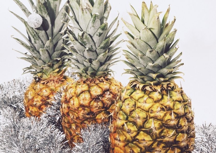 Three pineapples with silver tinsel and silver sprayed leaves