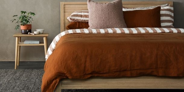 rustic bedroom with wooden bed and bedside table