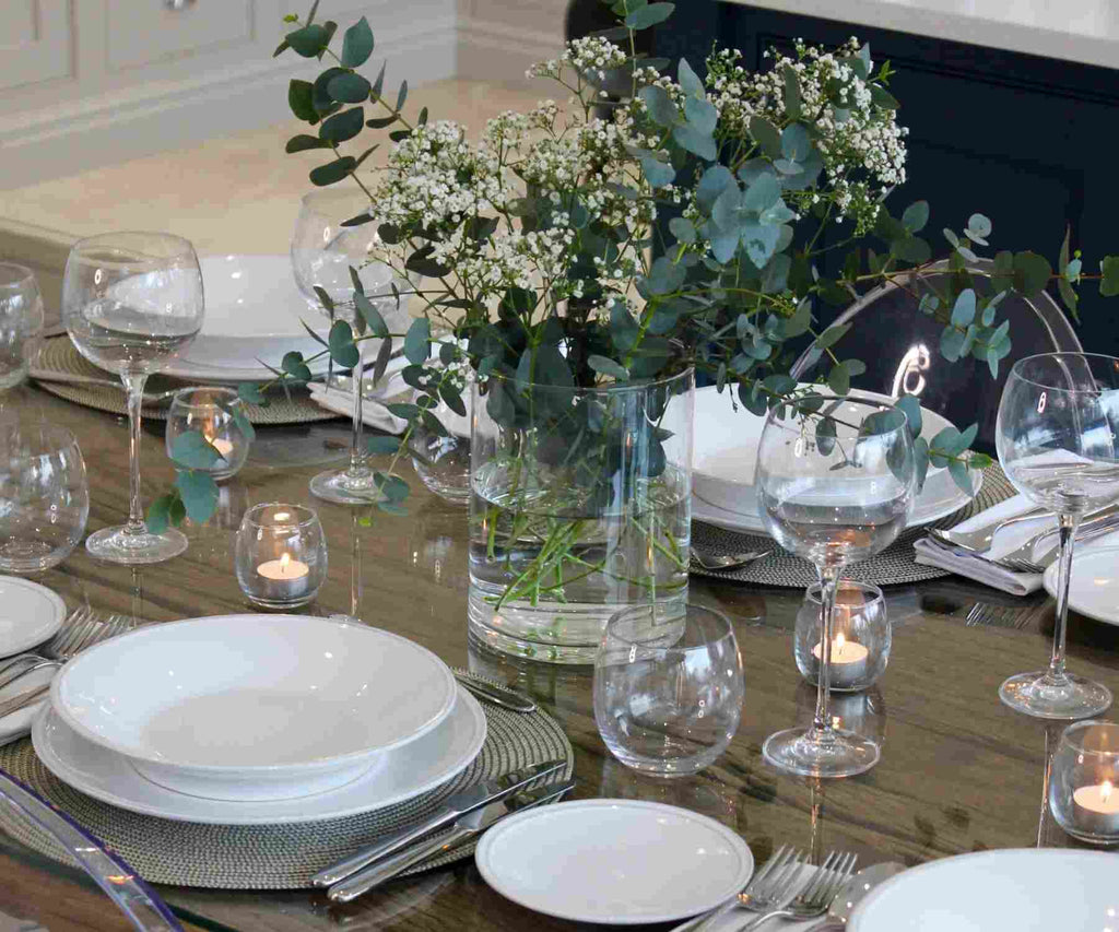 Flowers in glass jar on wooden table