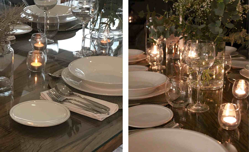 Candles and tea lights on a wooden dining table