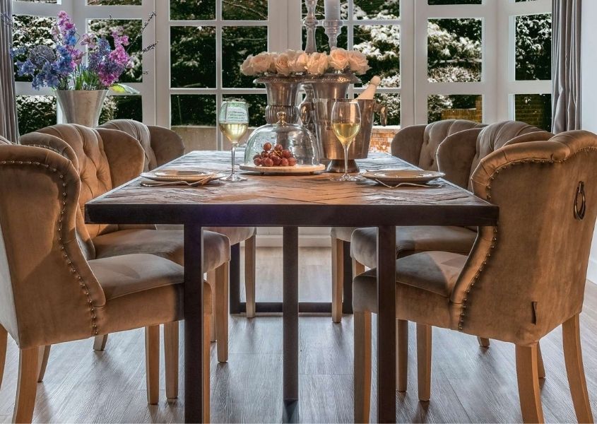 Industrial reclaimed wood dining table with velvet dining chairs