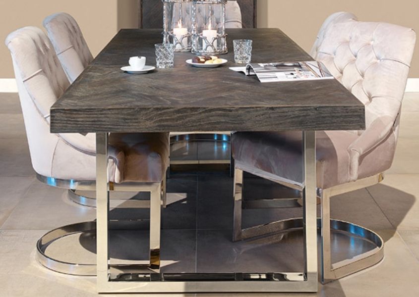 black oak dining table with silver legs and cream fabric dining chairs