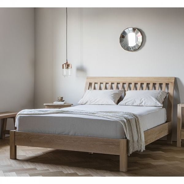 Hudson Living Marlow Solid Oak Bed King Size in Bedroom with white walls and bedside table and small round mirror