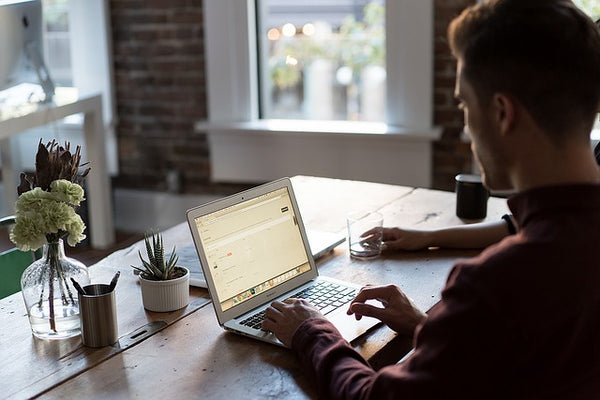 Man sitting at Reclaimed Wood Desk