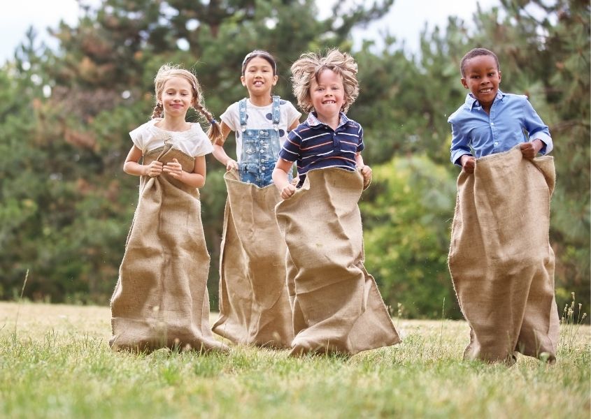 children in sack race for platinum jubilee garden party ideas blog