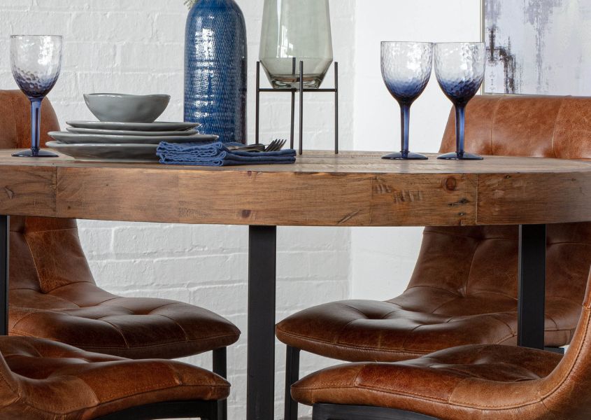 close up of small round dining table in reclaimed wood