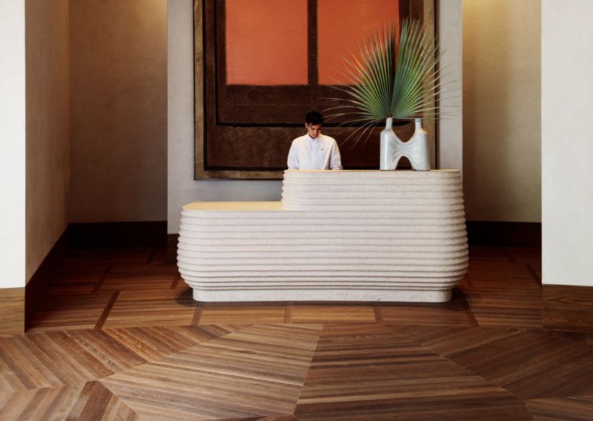 white hotel lobby desk with patterned wooden floor