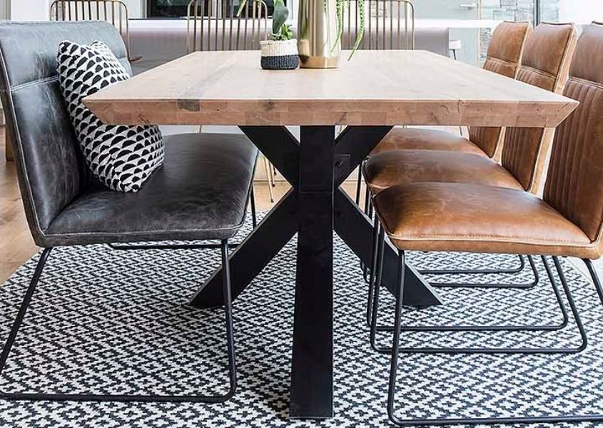 Wooden table with black steel spider legs and grey faux leather bench