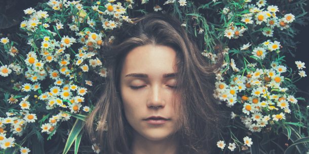 Girl asleep amongst the daisies