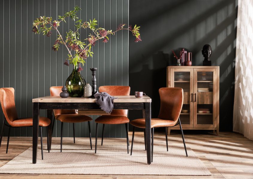 reclaimed wood dining table with black painted legs and brown leather dining chairs