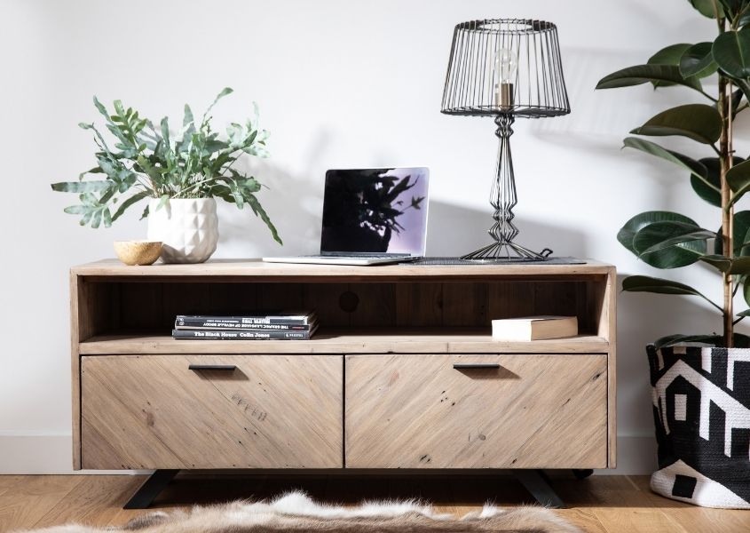 reclaimed wood tv stand with two cupboards and table lamp on top