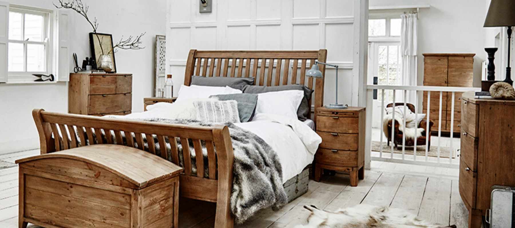 Reclaimed wood bed with blanket box and rug