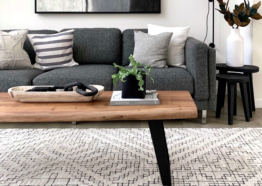 Wooden coffee table with small plant and wooden tray for Style tips to transform your coffee table blog