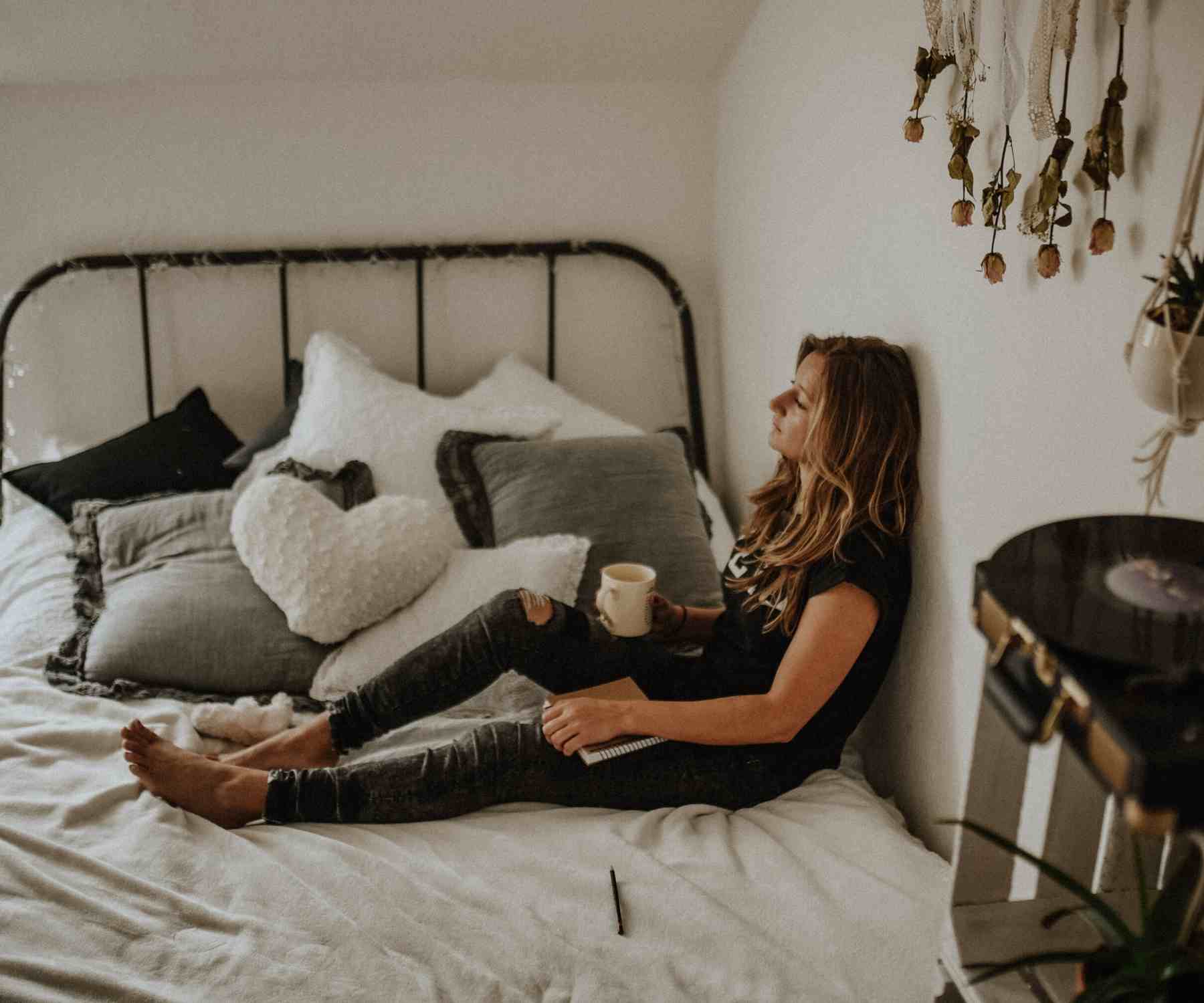 Teenage girl lying on metal bed