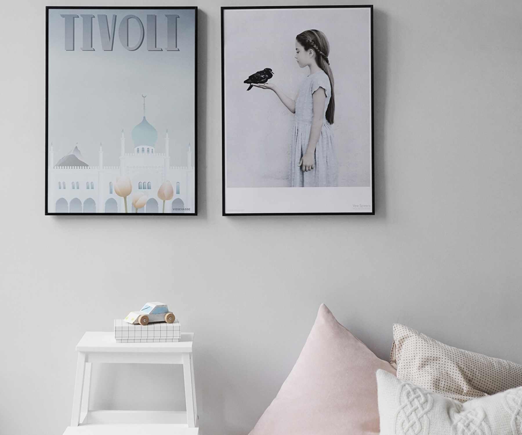 White bedroom with framed art on wall 