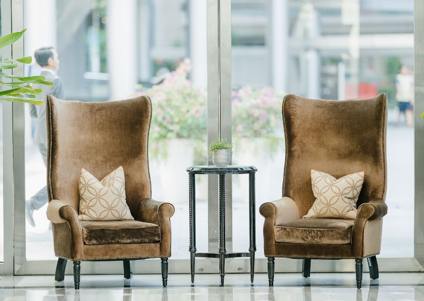pair of brown highback leather armchairs