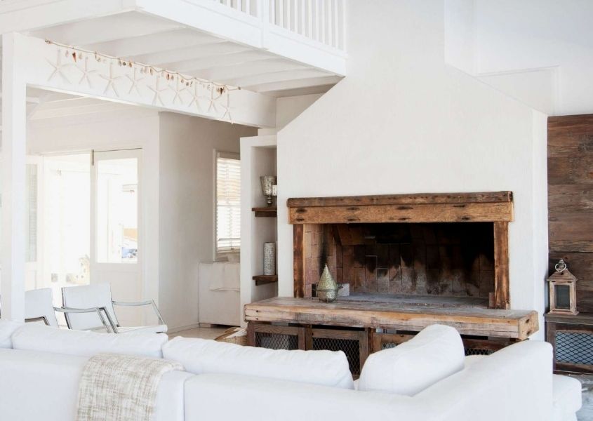 rustic living room with white fabric sofa and large open fireplace