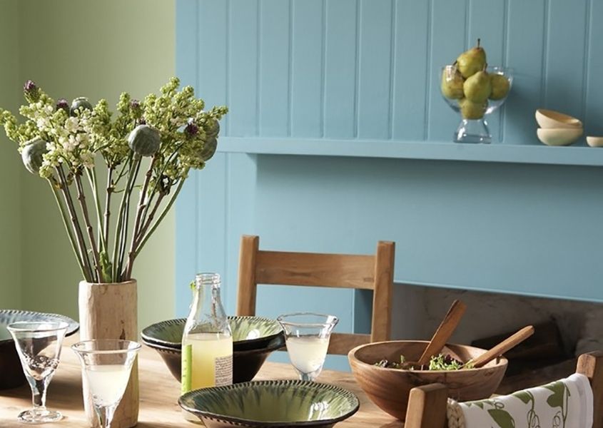 farmhouse table with wooden dining chair and stone vase with flowers