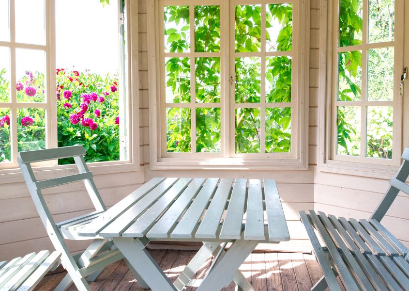 wooden outdoor table and chairs in garden room
