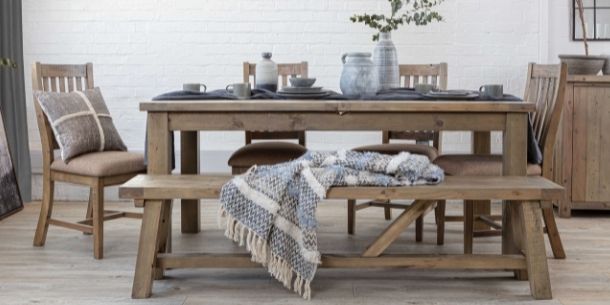 reclaimed wood dining table with matching wooden bench and wooden dining chairs