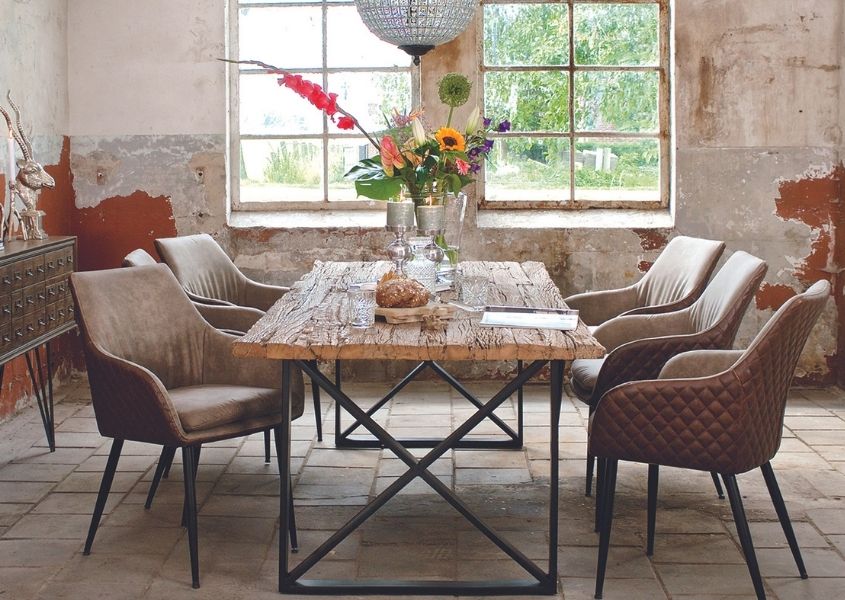 industrial dining table with large vase of flowers