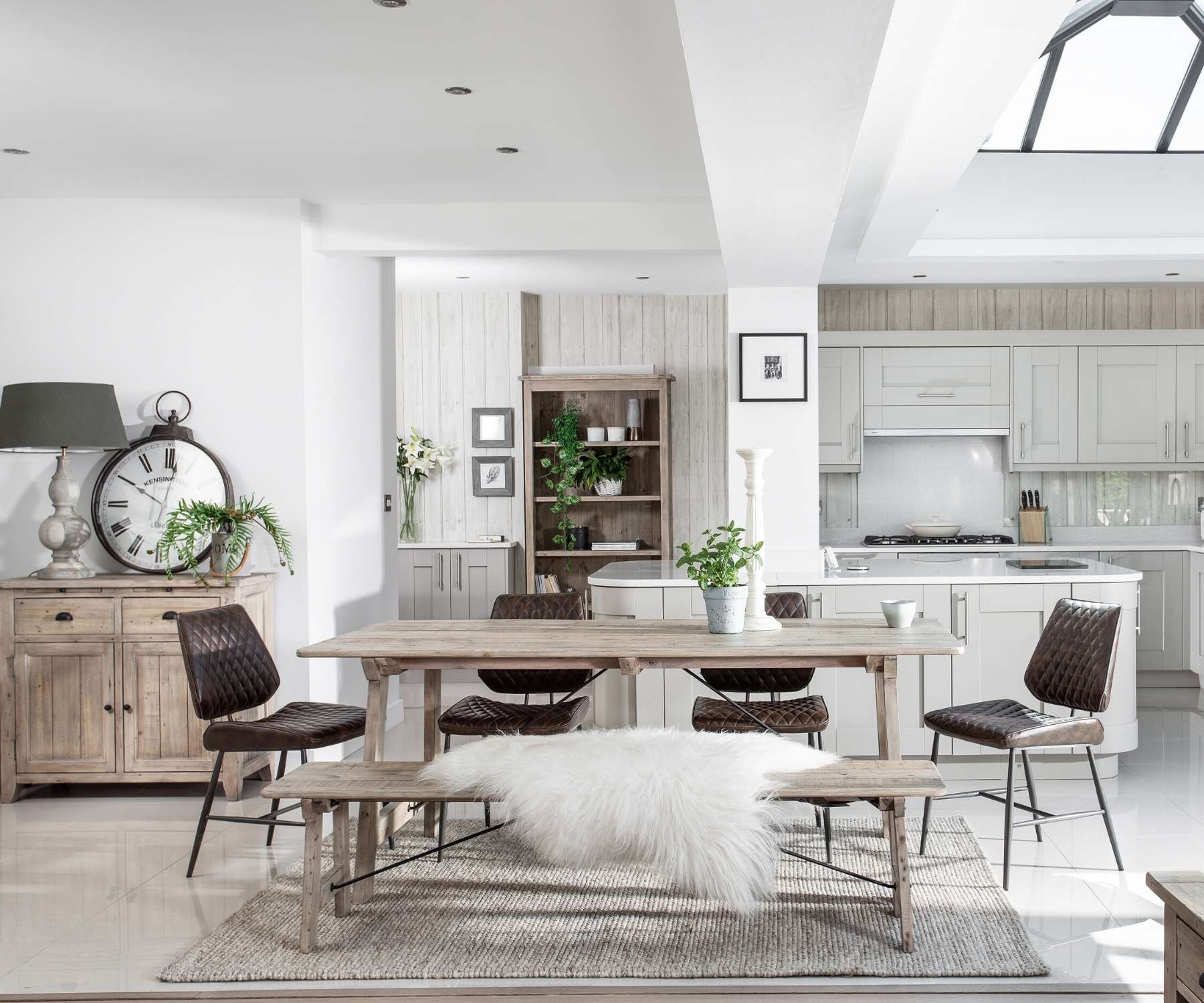 white kitchen with reclaimed wood table and sideboard