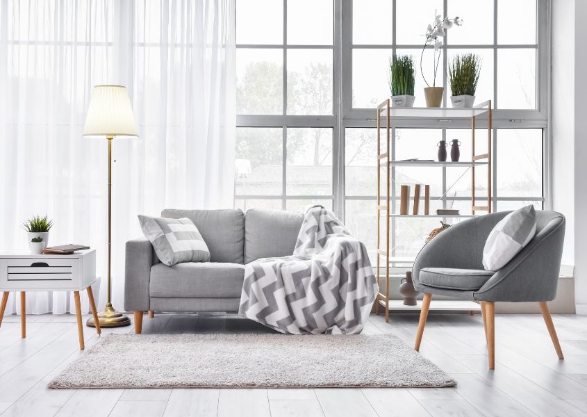 grey sofa with grey fabric armchair and white rug