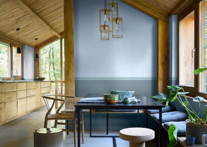wooden dining table and blue wall for why we love Dulux Colour of Year Bright Skies blog